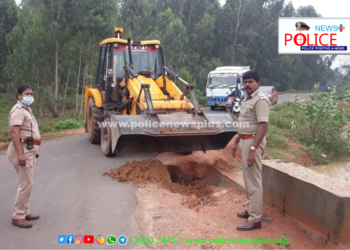 மழையினால் ஏற்பட்ட பள்ளத்தை சரி செய்த காவல்துறை